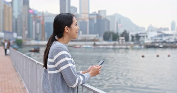 Woman use of mobile phone at outdoor alt