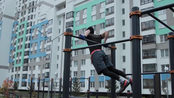 Muscular man training outdoors on sports field