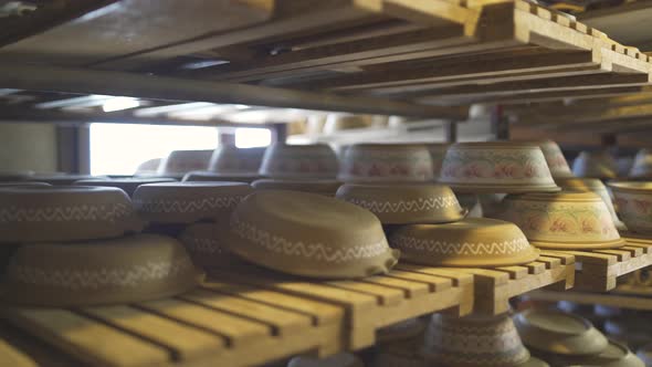 Close Up of Rows and Shelves of Various Colorful Clay Pottery Bowls alt