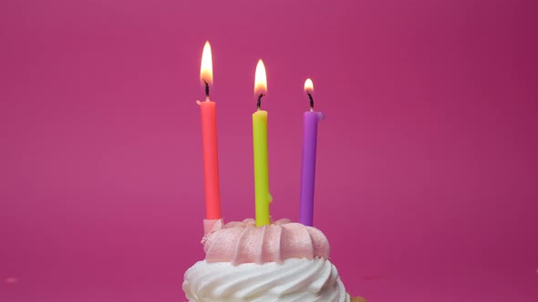 Birthday Cupcake with Candles and Birthday Decorations on Pink Background alt