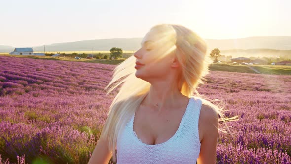 Portrait of a Blonde Woman with Hat in Lavender Fields on Summer