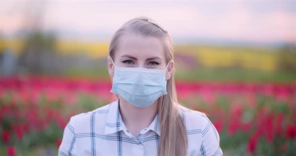 Woman Wearing Protective Mask Removing It and Taking a Deep Fresh Breath alt