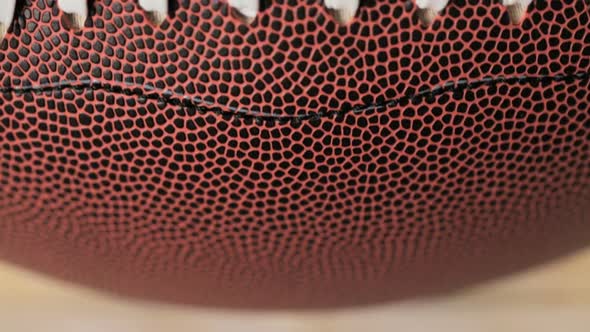 Close up of brown leather and white laces of American Football. alt