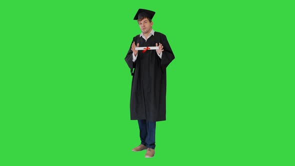 Male Student Graduation Robe Showing His Diploma Green Screen Chroma Key alt