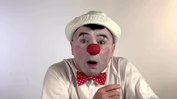 Emoji Clown. A sweet mime clown asks to call him on the phone. (Closeup shot size) alt