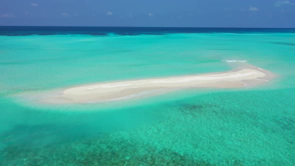 Wide aerial tourism shot of a sunshine white sandy paradise beach and blue ocean background in high  alt