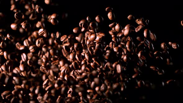 Super Slow Motion Shot of Exploding Premium Coffee Beans Isolated on Black at 1000Fps alt