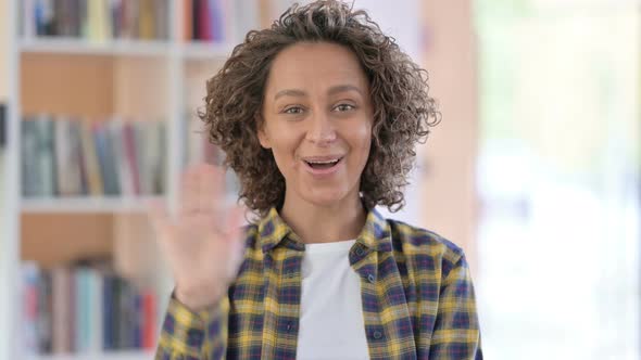 Portrait of Mixed Race Woman Waving, Welcoming alt