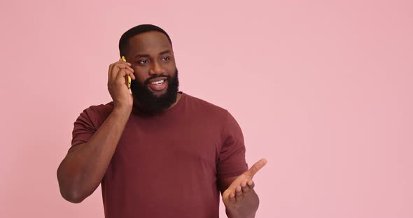 Young African American Man Talk on Phone Thumb Up Gesture Isolated on Pink Background alt