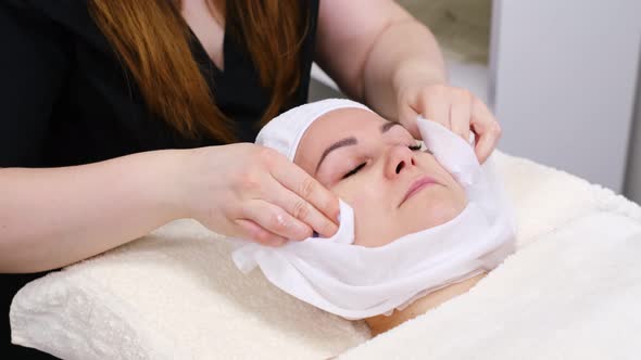 Young Woman Lying on a Stretcher in an Aesthetic Center Performing Beauty Treatment and Facial alt