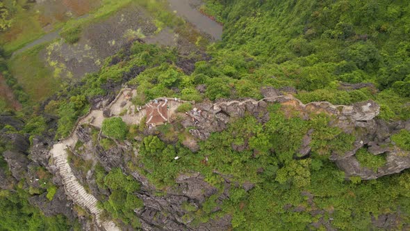 Aerial Shot of the Small Temple and a Dragon on the Top of Marble Mountain Mua Cave Mountain in Ninh alt
