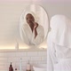 Young Black Woman Doing Face Massage with Quartz Roller in Bathroom - VideoHive Item for Sale