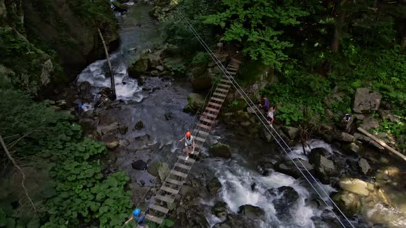 People at Extreme Park Attraction Above Mountains River alt