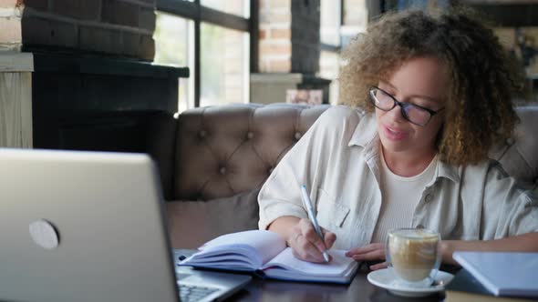 Distance Learning, Young Woman Talking with Teacher Via Video Link on Laptop Sitting at Table in alt