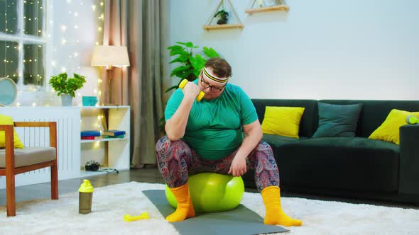 There s a Obese Man Sitting a Bright Yellow