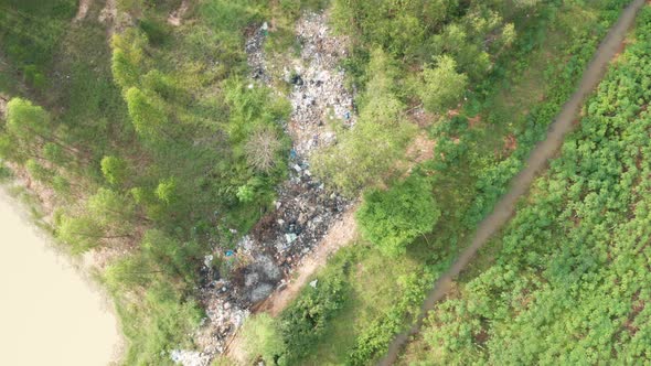 B roll of garbage dump in forest. Environment crisis. Garbage and fire burn.