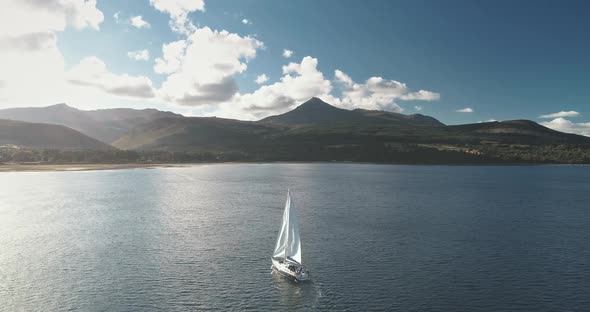 Slow Motion of Sailing Yacht at Mountain Ocean Coast