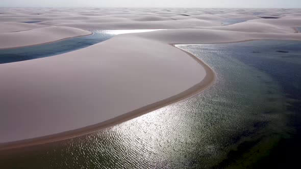 Paradisiac waves scenery of rainwater lakes and sand dunes at Brazil. alt