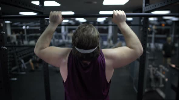 Man Trying to Pull Up His Heavy Body, Increase Muscle Strength, Workout in Gym alt