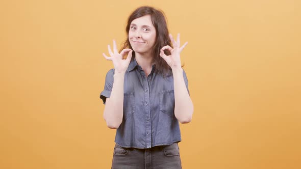 Pretty Young Woman Showing Ok Sign As Approval for a Great Job alt