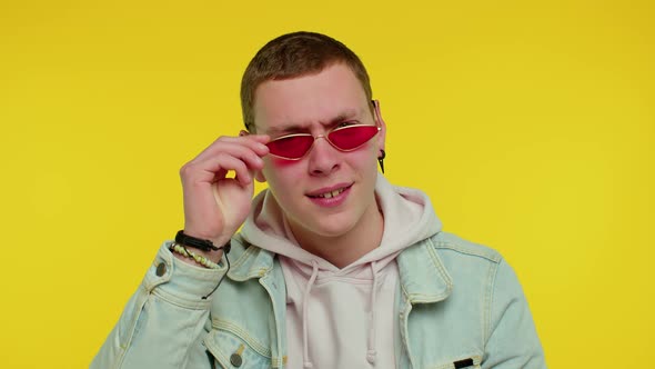 Cheerful Happy Man Wearing Sunglasses Blinking Eye Looking at Camera with Smile Winking and Flirting alt