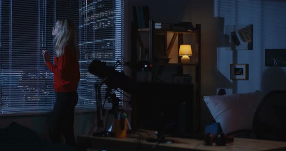 Woman Looking Out of Window alt