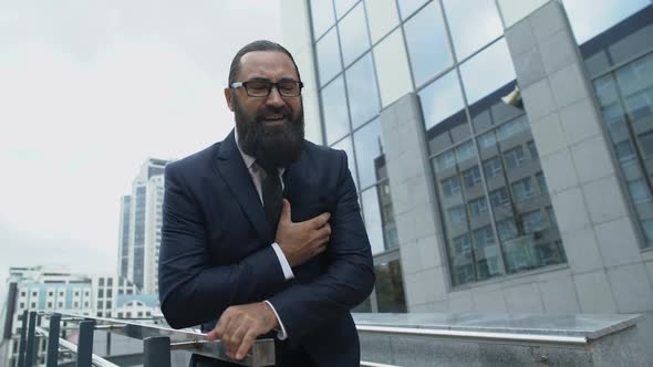 Business Man Helping His Boss With Heart Attack and Calling Ambulance, First Aid