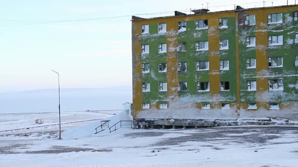 Frozen Block of flats in Siberia. Tiksi .Painted blocks of Russia. Abandoned flats in Tiksi. alt