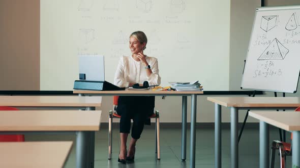 A Lady Is Having an Online Class in the Empty Classroom alt