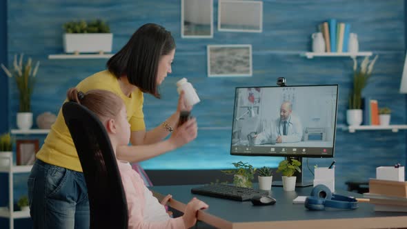 Mother Using Video Call with Doctor for Healthcare Treatment alt