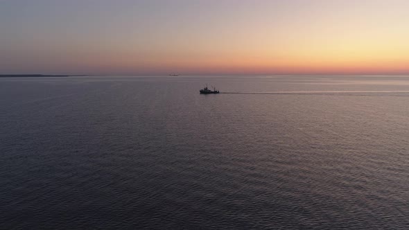 Fishing Boat Trawler Sailing on Sea at Sunset Aerial Shot alt