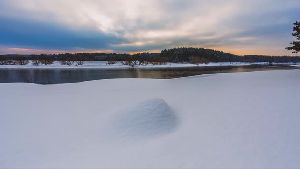 Winter Sunset Timelapse with Snow and River Stream in the Background