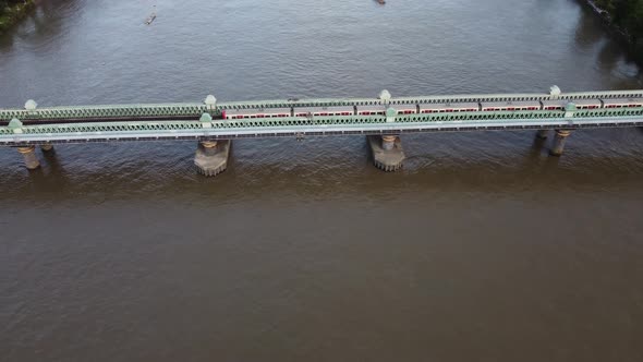 A Drone View of the Fulham Railway Bridge Up Close with a Train Driving Over It