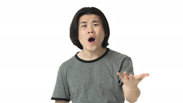 Portrait of Annoyed or Angry Chinese Man in Casual Gray Tshirt Expressing Misunderstanding with alt