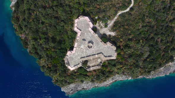 Aerial top down view of triangular Porto Palermo castle, situated in the bay of Porto Palermo. alt