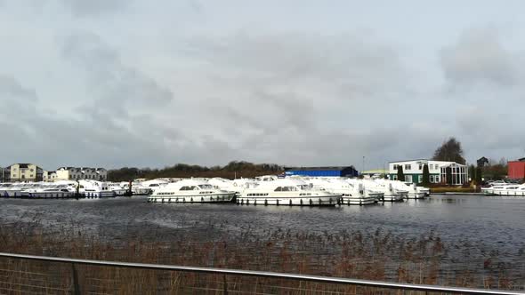 Aerial - Boat park at the jetty on a lake. Nearby residential houses area. alt