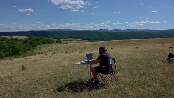 Graphic designer with laptop working with laptop and graphic tablet outdoor alt