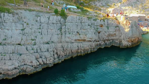Rocky Wall Of Cliffs In The Adriatic Coast In Klancac Beach In Brsec, Croatia. - aerial alt