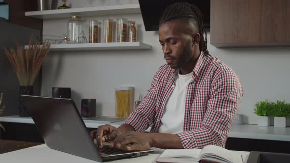 Successful Black Male Freelancer Networking with Laptop Pc on New Business Project at Home alt