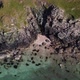 Drone View of Hidden Beach Waves and Cliffs Amongst Mountain Landscape Scotland - VideoHive Item for Sale