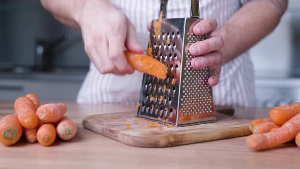 Grating Carrot In The Kitchen For Baking Cake. close up alt