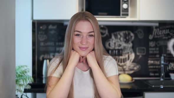 Woman Looking at Camera Working at Home alt