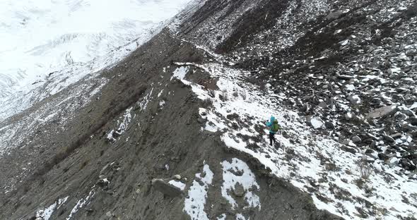 Woman backpacker climbing mountains in winter nature  alt