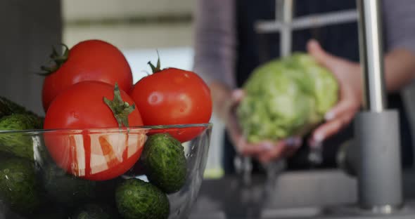Woman Washes Ingredients for Salad  Under a Stream of Water Holds Cabbage Head alt