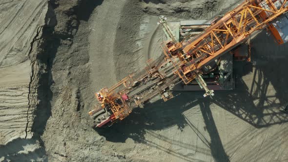 Aerial View of Bucket Wheel Excavator in Process of Mining Natural Resource. Heavy Industry. alt