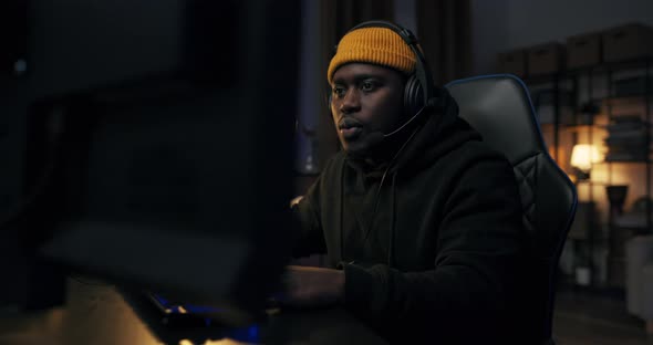 Dynamic Shot Around Gamer Playing on Computer alt