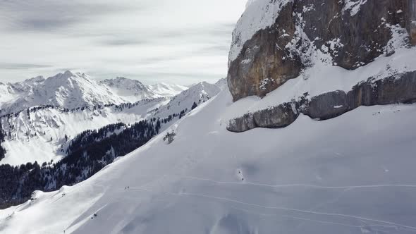 Aerial drone shot on montain rock in the alps, Austria, Kleinwalsertal, skiing area, snowy mountains alt