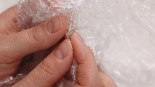 Nervous Woman Presses Plastic Bubble Wrap as a Stress Relief