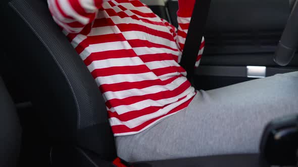 Woman Fastening Car Safety Seat Belt While Sitting Inside of Vehicle Before Driving alt