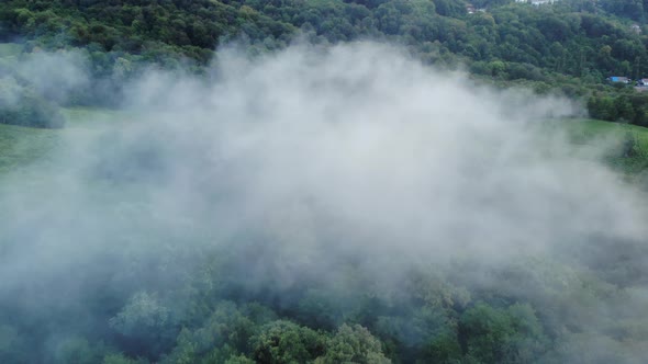 Aerial Drone Footage View: Flight Over Mountain Village with Forest in Sunrise Soft Light. Majestic alt